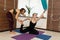 Couple womans doing fly yoga stretching exercises in gym. Fit and wellness lifestyle