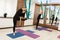 Couple womans doing fly yoga stretching exercises in gym. Fit and wellness lifestyle