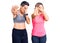 Couple of women wearing sportswear covering eyes with hands and doing stop gesture with sad and fear expression