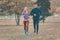 Couple in wonderful fall landscape running for better fitness