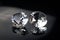 Couple of wonderful pure diamonds with reflections on black mirror background close up view. Jewelry diamonds sale, invitation,