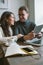 Couple working in cafe with tablet, laptop, smartphone, notepad