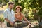 Couple Working In Vegetable Garden Or Allotment Carrying Tray Of Beets