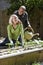 Couple working on vegetable garden in backyard