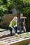 Couple working on vegetable garden in backyard