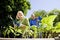 Couple working on vegetable garden in backyard