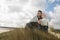 Couple Wrapped In Blanket On Beach