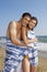 Couple Wrapped In Towel Standing At Beach