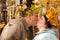 Couple with wreath of leaves kissing in forest