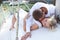 Couple on yacht in love. Honeymoon. A man kissing a woman in the neck while lying on the deck.