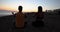 Couple yoga for meditation and meditating at serene sunset on beach
