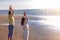 Couple yoga on the river beach at sunrise.