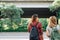 Couple of young Asian women standing along the street enjoying their city lifestyle on weekend waiting for outdoor activity.