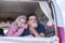 Couple of young beautiful cacuasian travelers inside an old vintage van legendary vehicle stay happy and enjoy the leisure and the