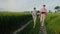 A couple of young farmers walk along a country road between wheat fields