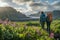 A couple of young hikers with heavy backpacks admiring scenic view of spectacular Icelandic nature. Breathtaking landscape of