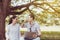 Couple young lover sitting and playing together at park,Romantic and enjoying in moment of happiness time,Happy and smiling