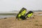 A couple of young men struggle against a stiff breeze to prepare their para glider for an afternoons sport at the Titchfield beach