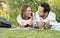 Couple of young students have fun while studing in the park