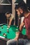 couple of young successful handsome men playing in pool