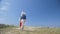 Couple of young women walking sandy beach at the day Indie boho style Swimwear and shorts