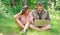 Couple youth spend leisure outdoors with laptop. Modern technologies give opportunity to be online and work in any