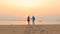 Couples of asian man ,woman happiness on sea beach with sun rising sky