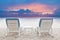 Couples of chairs beach on white sand with dusky sky background