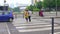 A couples crossing the road by holding hand on the zebra lines in the Kuala Lumpur street