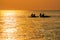 Couples Enjoy Golder Sunset while Kayaking out on the Sea