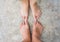 Couples feet on the concrete ground close up