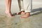 Couples feet standing on beach