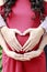 couples hand on pregnancy heart shape