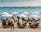 Couples have drinks and appetizers at a luxurious restaurant on the beach in the French Riviera resort town of Juan les