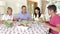 Couples seated around dining table