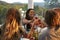 Couples toasting at dinner on a terrace, over shoulder view