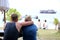 Couples tourists enjoying ocean views on the beach.