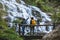 Couples travel relax to photograph the waterfalls beautiful. In the winter. at the waterfall mae ya chiangmai in thailand. travel