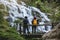 Couples travel relax to photograph the waterfalls beautiful. In the winter. at the waterfall mae ya chiangmai in thailand. travel