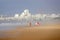 Couples walking in sea mist on beach