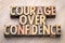 Courage over confidence word abstract in wood type