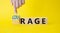 Courage and rage symbol. Businessman hand points at wooden cubes with words Rage and Courage. Beautiful yellow background.