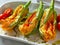 Courgette flowers stuffed with pizzottella and some tomato