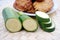 Courgette or zucchini vegetables with homemade fritters in the background