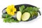 Courgettes cut into slices with flower and leaves on white