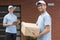 Courier in blue uniform holding a package