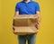 Courier with damaged cardboard box on background, closeup. Poor quality delivery service