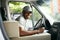 Courier Delivery. Black Man Driver Driving Delivery Car