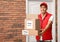 Courier holding parcels with stickers Free Delivery