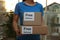Courier holding parcels with stickers Free Delivery indoors